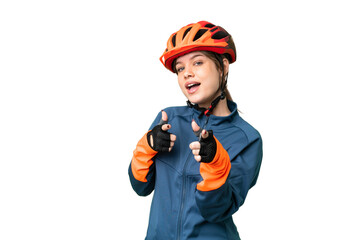 Young cyclist girl over isolated chroma key background pointing to the front and smiling
