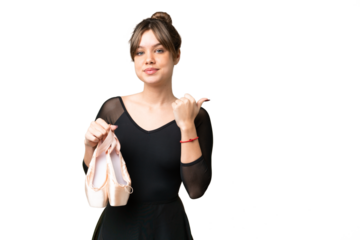 Young girl practicing ballet over isolated chroma key background pointing to the side to present a product