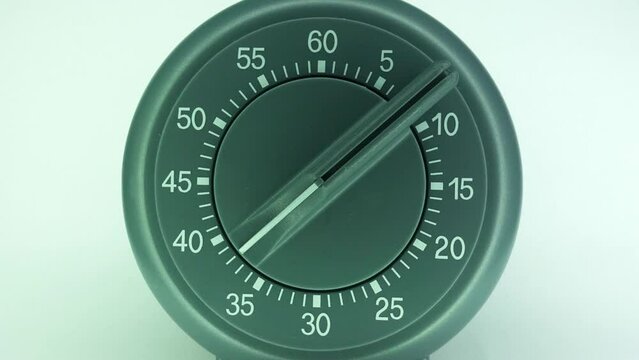 Kitchen timer close up time-lapse count down from one hour to zero.
