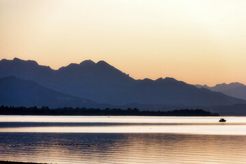 impression of lake chiemsee with golden shining light at the evening