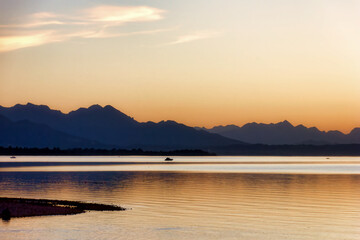 impression of lake chiemsee with golden shining light at the evening