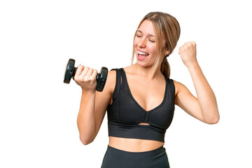 Blonde sport woman making weightlifting over isolated chroma key background celebrating a victory