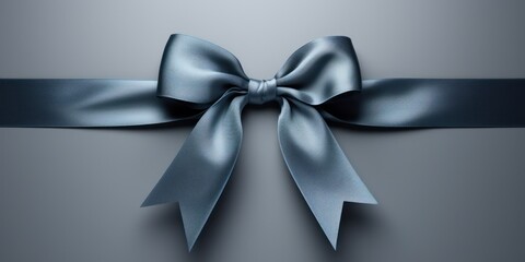 Blue gift ribbon with a bow against a gray background - obrazy, fototapety, plakaty