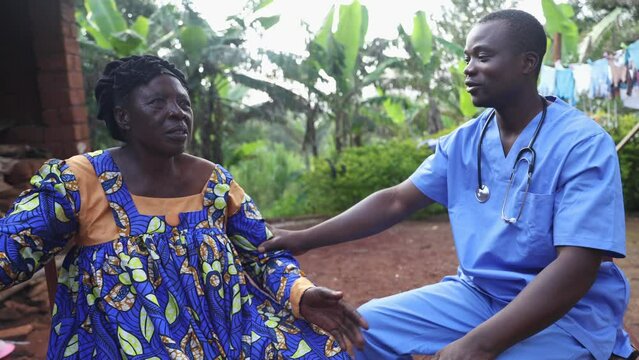 During a home medical visit, an African doctor talks to his elderly patient and hears her heartbeat
