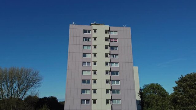 Drone 50fps. High rise block of flats in working class suburban council estate. Manchester. UK.
