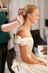 Hairdresser, wedding and woman styling for long, healthy and bridal hairstyle on a young model....