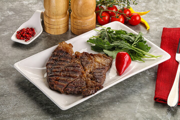 Grilled chuck roll steak with arugula