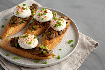 Homemade Creamy Mushroom Toasts on a Plate, side view.