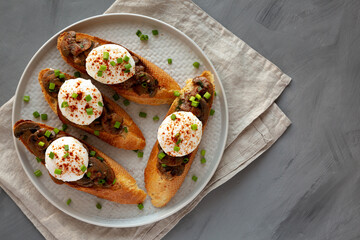 Homemade Creamy Mushroom Toasts on a Plate, top view. Flat lay, overhead, from above. Copy space.