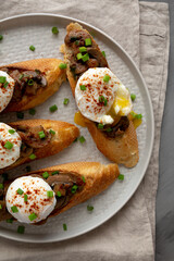 Homemade Creamy Mushroom Toasts on a Plate, top view.