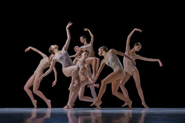 Tender, elegant young people, ballet dancers making beautiful performance on stage against black background. Concept of classical and modern dance, beauty, creativity, art, theater