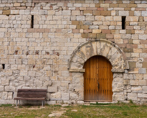 "Sit and wait"—a bench and fragment of the Santa Maria de Miralles chapel wall (13th century) @ Santa Maria de Miralles, Catalonia, Spain.