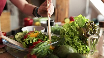 girl mixing fresh healthy vegetable salad in the bowl on the kitchen table, homemade cooking healthy food - Powered by Adobe