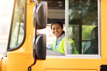 Happy Black School Bus Female Driver Smiling At Camera Through Open Window