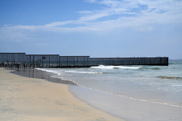A fence on the United States - Mexico border where it meets the Pacific Ocean in Border Field State Park Beach