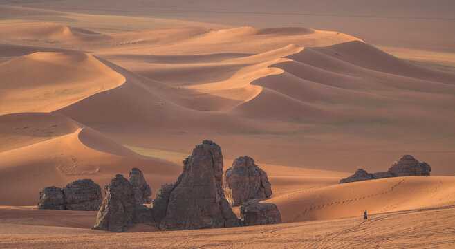 Aerial View of sand dunes with rock formation at sunset in the Sahara desert, Djanet, Algeria, Africa.