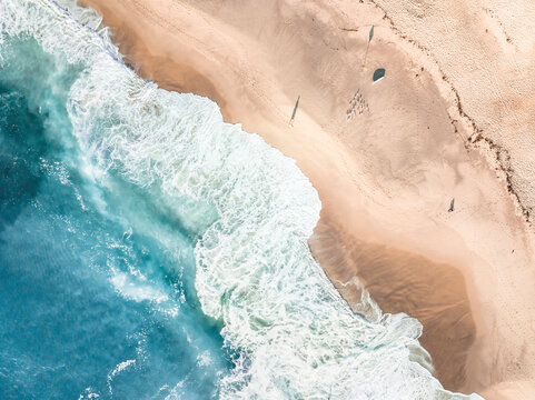Aerial Top Down View Of Blue Ocean Waves Breaking Onto Sand At Bronte Beach, Sydney, Australia.