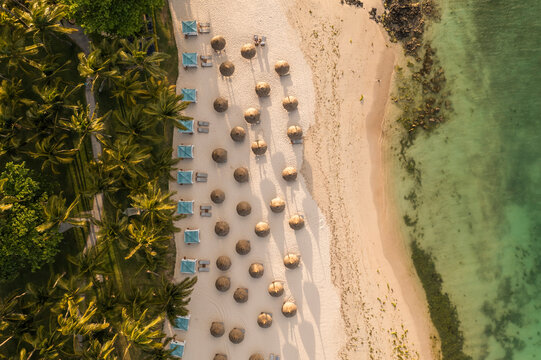 Aerial view of umbrella on the beach along the shoreline in Poste de Flacq, Flacq district, Mauritius.