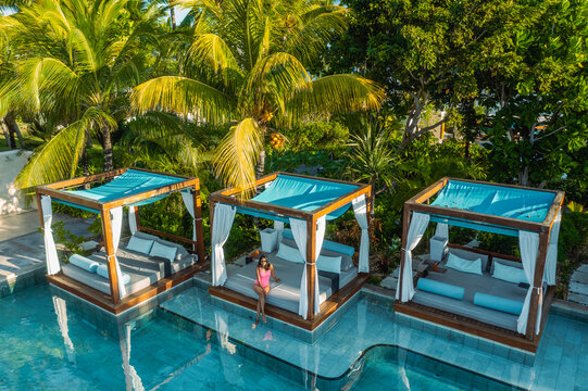 Aerial view of a woman relaxing along the swimming pool in a luxury resort, Poste de Flacq, Flacq district, Mauritius.
