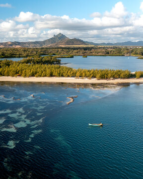 Aerial view of a fishing boat along the coastline of Ilot Mangenie island, Ilot Lievres, Flacq, Mauritius.