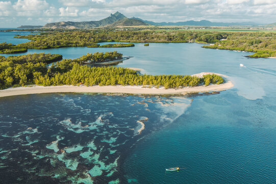 Aerial view of a fishing boat along the coastline of Ilot Mangenie island, Ilot Lievres, Flacq, Mauritius.