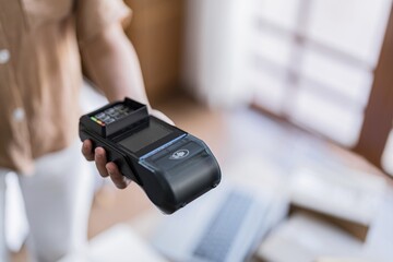 Contactless payment holding credit card with touch settlement paying for shopping nfc technology transaction cashless technology and credit card payment