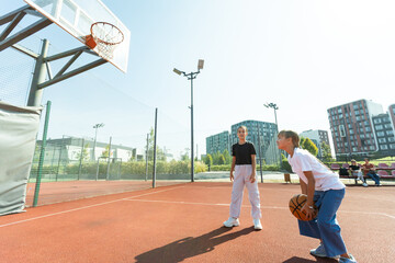 children schoolchildren playing a match about basketball against the background 