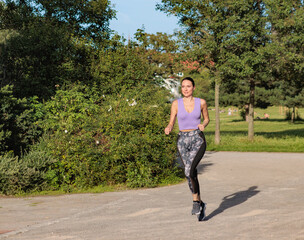 Fit woman exercising outdoors. Healthy young female athlete doing fitness workout.