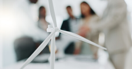 Business people, meeting and wind turbine for eco friendly, sustainability and renewable energy planning in office. Windmill model, design and engineering team with documents in agriculture solution - obrazy, fototapety, plakaty