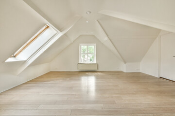 an empty room with wood floors and skylights in the corners on the right side of the room, there is...