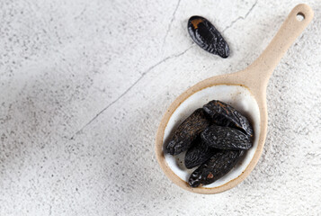 tonka beans in a ceramic spoon on the table