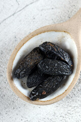 tonka beans in a ceramic spoon on the table