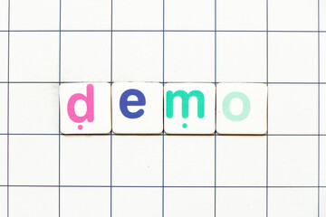 Colorful tile letter in word demo on white grid background
