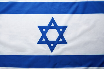 Israel flag. Independence Day of Israel. Israel flag beautifully waving wave with star of David over white wooden background. National pride of Israel. Patriotism and commonwealth. Top view. Mock up.