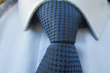 stylish blue office tie on a blue shirt tied in a knot