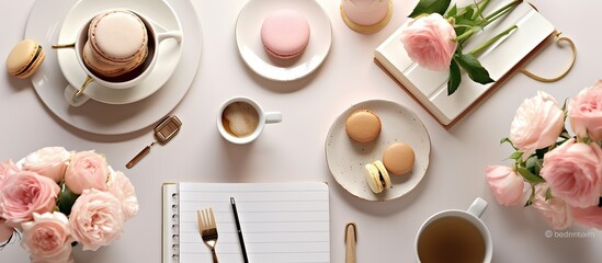 Workspace with diary, pen, vintage white tray, sakura, roses, croissants and coffee on white...