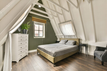 a bedroom with a bed, dresser and chair in the corner of an attic - style room that has been used for several years