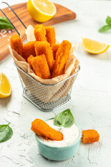 Golden roast Fish Sticks Fingers with sauce. Food recipe background. Close up
