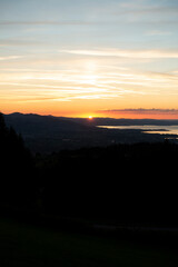 sunset over the lake in the golden hour seen from a mountain