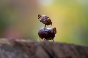 Good-hearted chestnut dog animal with cute face on natural background, traditional autumnal handcraft with children