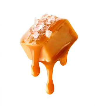 Flying salty caramel candy topped with salt crystals and pouring caramel sauce