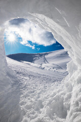 view through snow cave into winter landscape, rofan alps