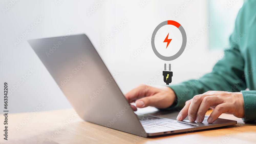 Leinwandbilder laptop out of battery. concept of technology and daily life. man is angry and frustrated when he lea
