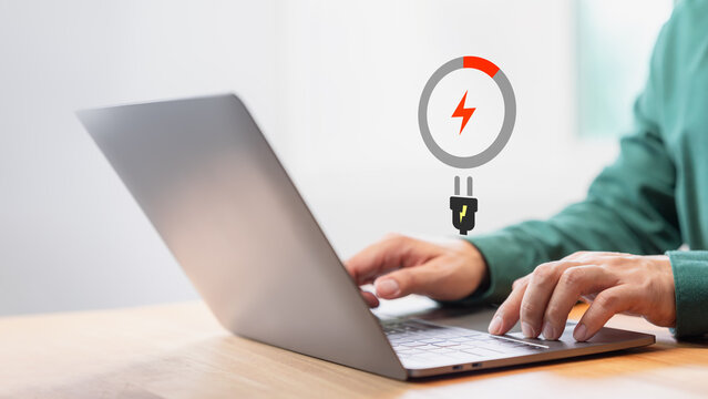 Laptop out of battery. Concept of Technology and daily life. Man is angry and frustrated when he learns that his laptop computer's battery is dead and did not bring the charger adapter.