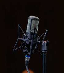  studio condenser microphone on a microphone stand.