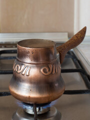 coffee is brewed in a Turk on the stove in the home