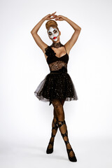 Sexy woman in a Halloween costume and ballerina makeup. Halloween makeup and costume concept.