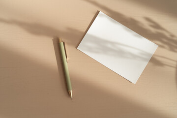 Empty white paper mock up with leaves shadows. Business or holidays card with copy space