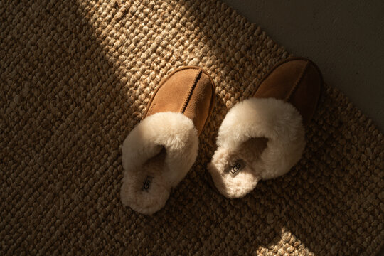 MINSK, BELARUS - October, 2023: Top view on comfortable UGG slippers at home 