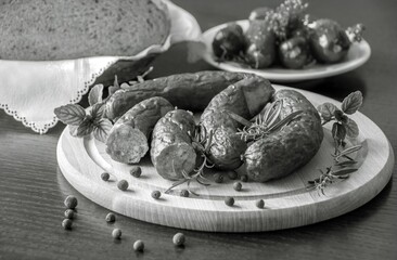 Tasty sausages and vegetables isolated over solid background
